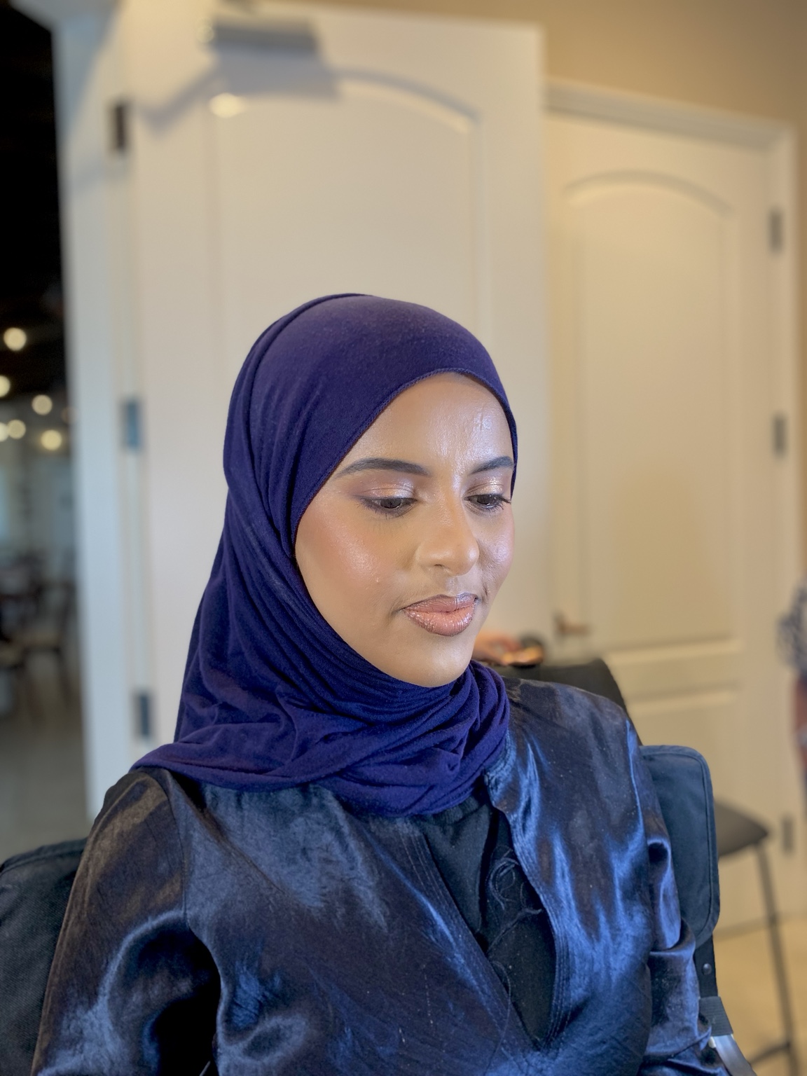 Polished makeup on a client wearing a navy hijab