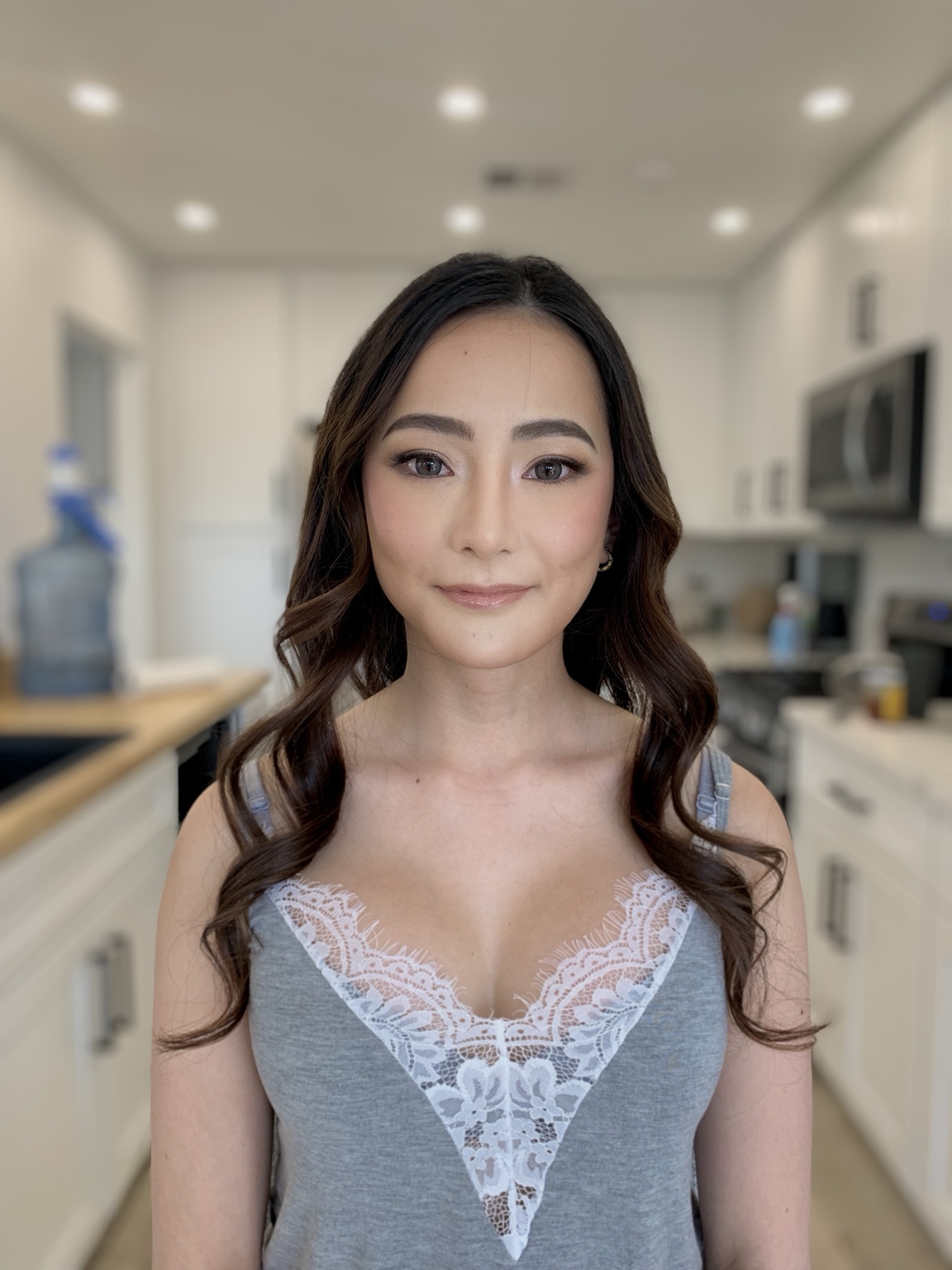 Finished hair and makeup with brunette waves